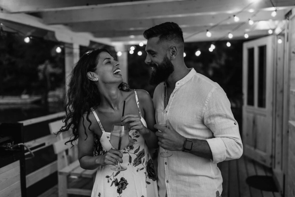 smiling couple celebrating with wine 2023 02 15 20 32 20 utc scaled 1